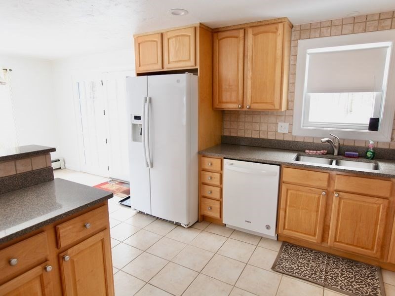 54 Ann Street Raynham, MA 02767 - Photo 5 of 21 a kitchen with stainless steel appliances granite countertop a refrigerator sink and cabinets