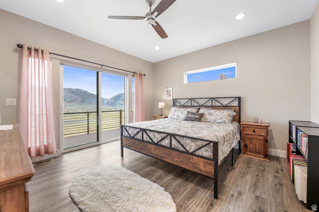 4527 North Seven Bridges Road Eden, UT 84310 - Photo 18 of 65 Bedroom with a mountain view, wood finished floors, access to outside, ceiling fan, and recessed lighting
