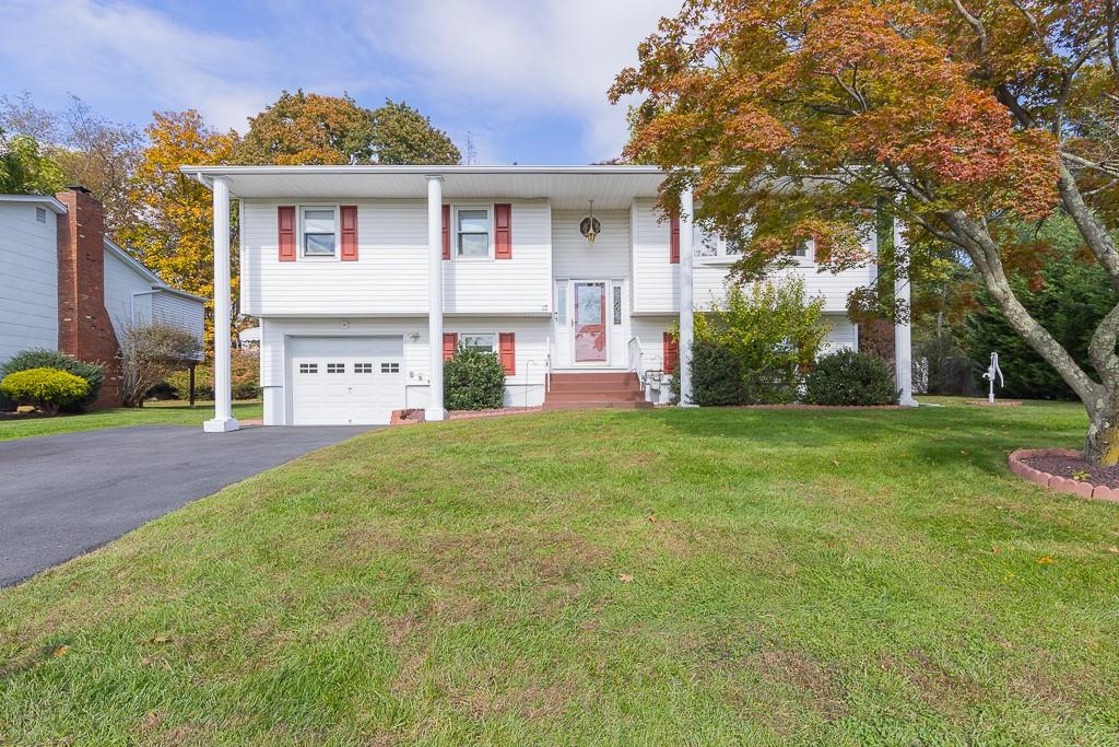 a front view of house with yard and green space
