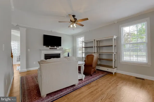 a living room with a fireplace a flat screen tv and a lamp