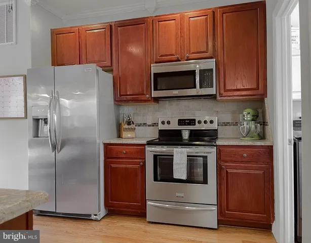 a kitchen with granite countertop cabinets and window