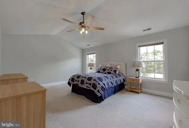 a bathroom with a granite countertop bathtub a sink and a large mirror