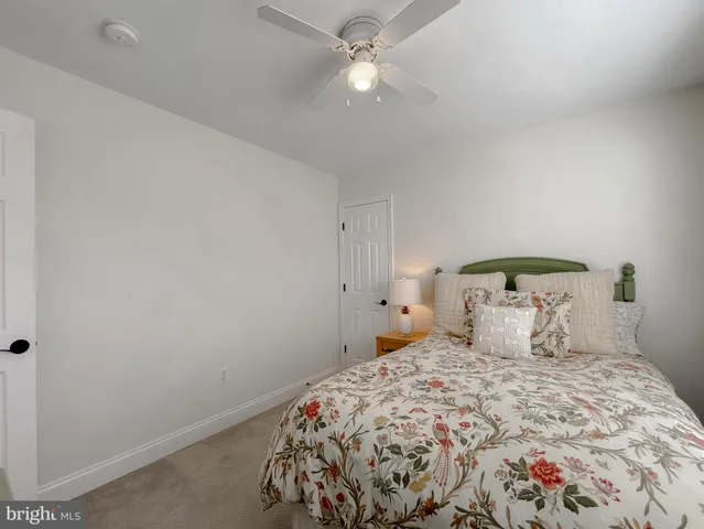a bathroom with a sink a toilet and shower curtain
