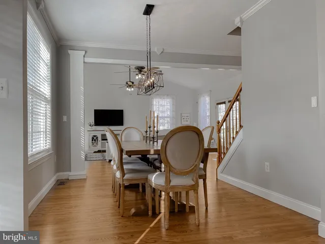 a view of dining room filled with furniture window and wooden floor
