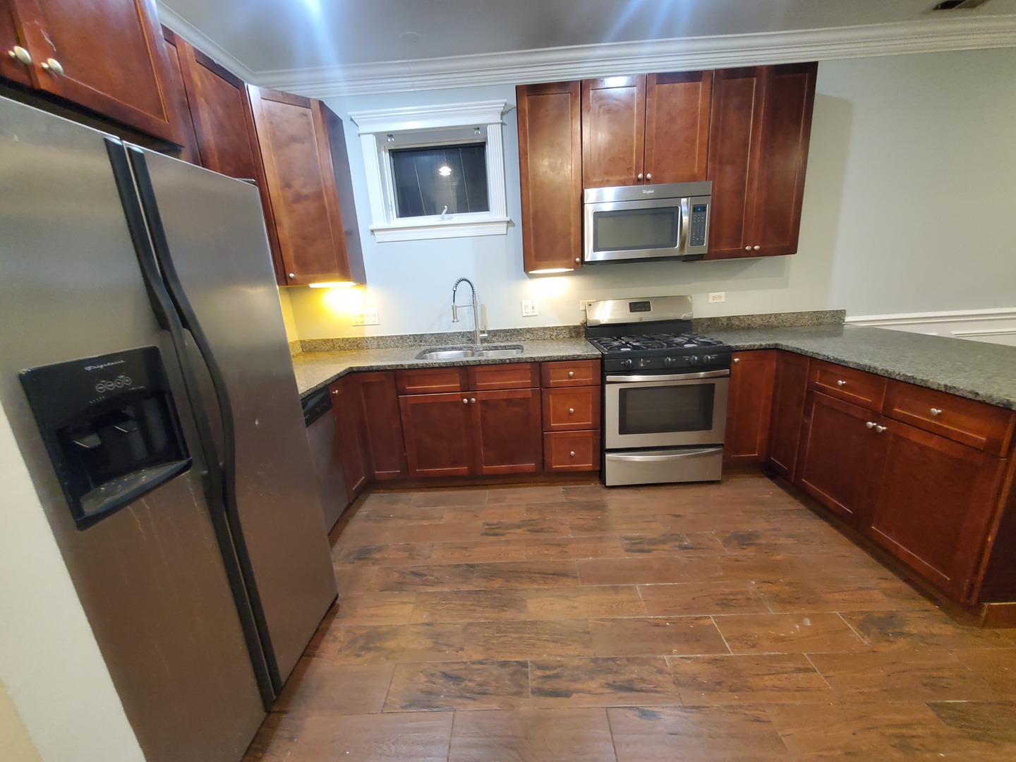 Undisclosed Address Chicago, IL 60645 - Photo 16 of 22 a kitchen with stainless steel appliances granite countertop a refrigerator a stove top oven a sink and dishwasher