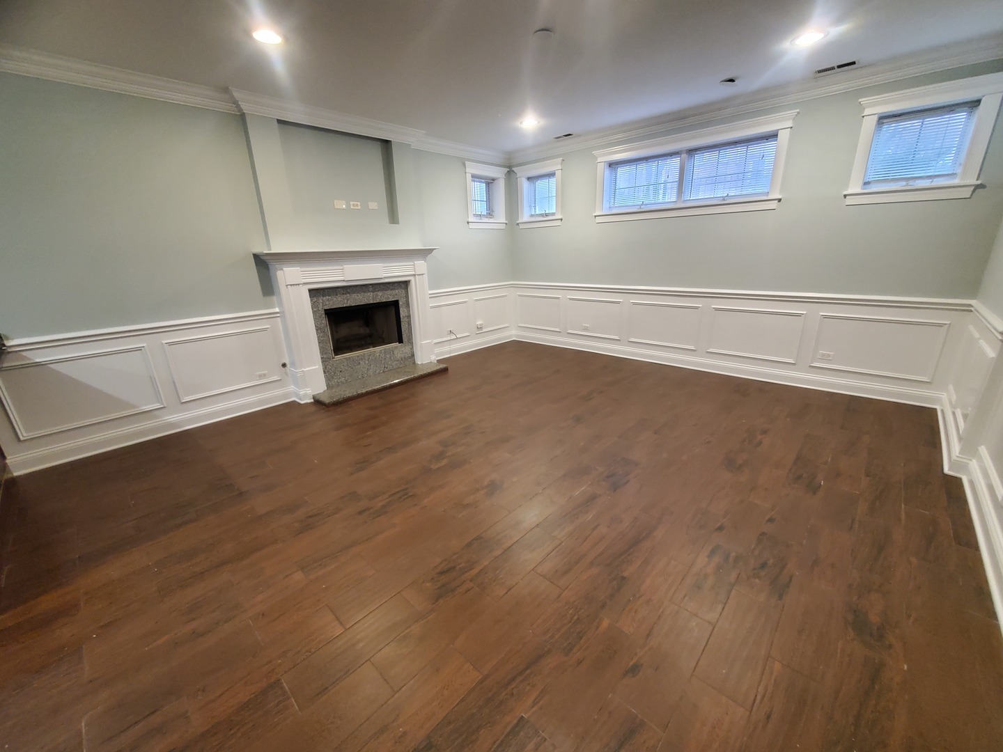 Undisclosed Address Chicago, IL 60645 - Photo 2 of 22 an empty room with wooden floor fireplace and windows