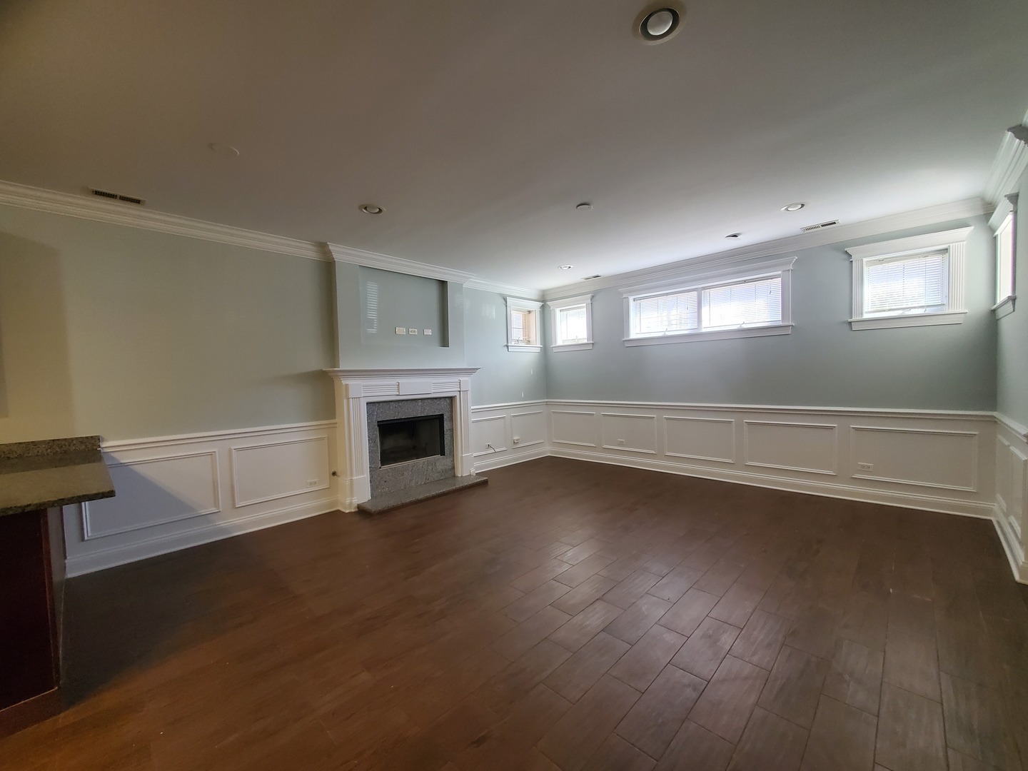 Undisclosed Address Chicago, IL 60645 - Photo 5 of 22 a view of a livingroom with wooden floor a fireplace and window