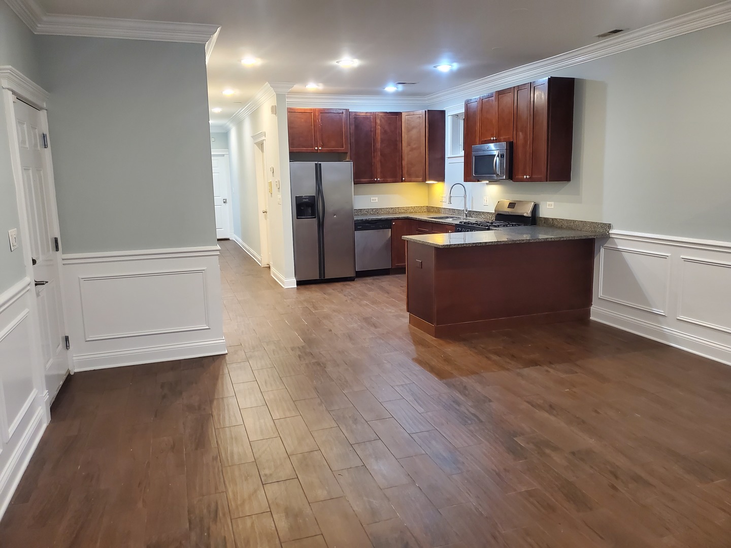 Undisclosed Address Chicago, IL 60645 - Photo 6 of 22 a kitchen with stainless steel appliances granite countertop a refrigerator and a stove top oven