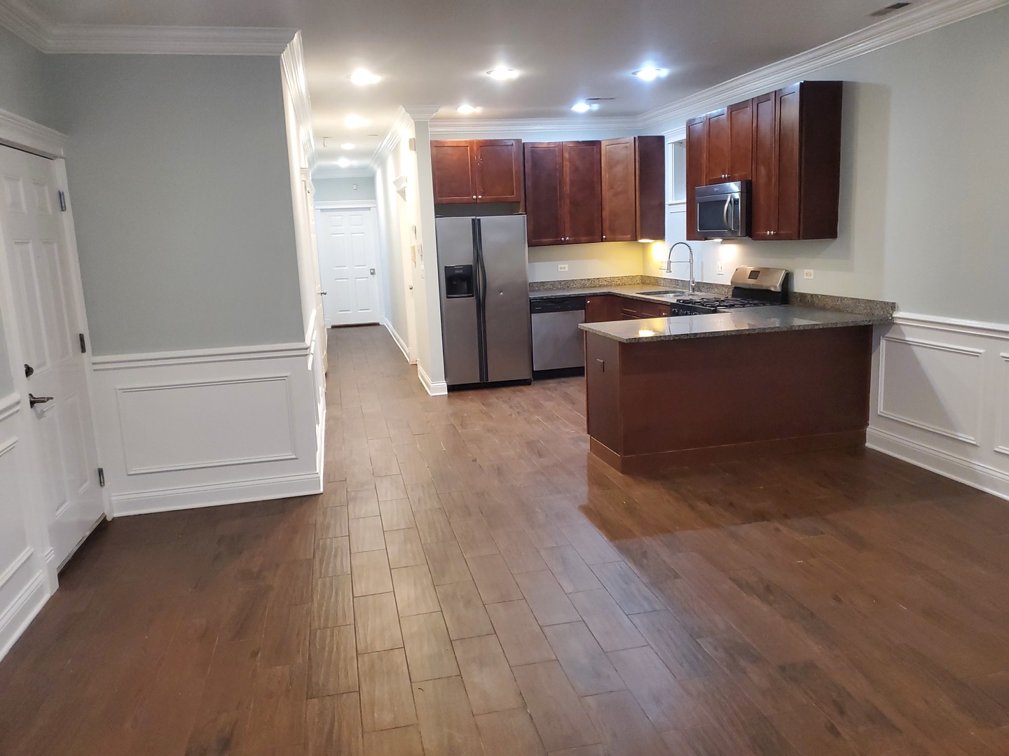 Undisclosed Address Chicago, IL 60645 - Photo 7 of 22 a kitchen with stainless steel appliances granite countertop a refrigerator and a stove top oven