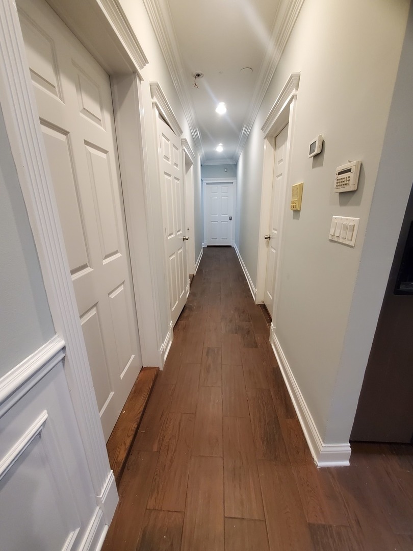 Undisclosed Address Chicago, IL 60645 - Photo 8 of 22 a view of a hallway with wooden floor and staircase