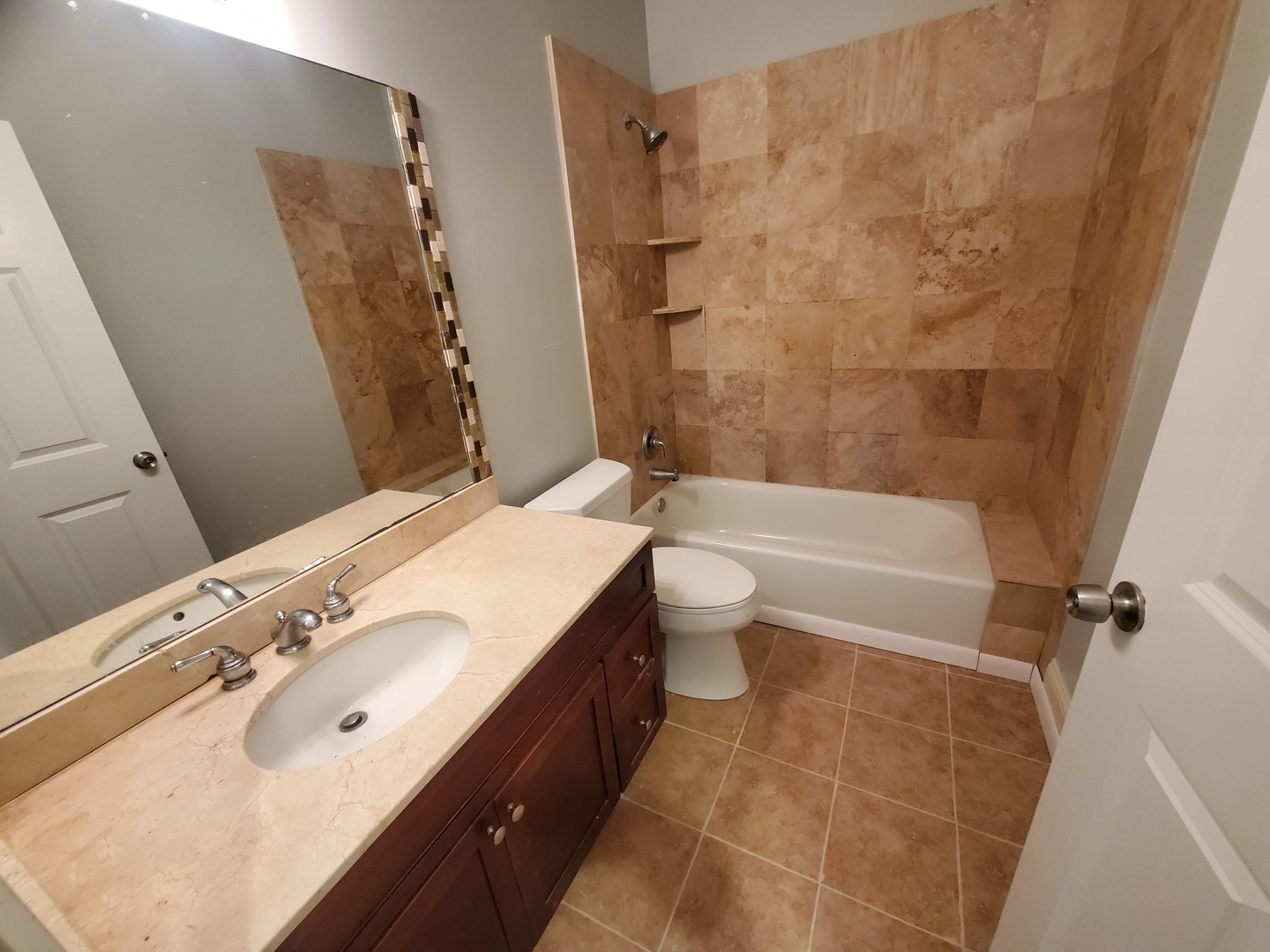 Undisclosed Address Chicago, IL 60645 - Photo 10 of 22 a bathroom with a bathtub shower sink vanity and toilet