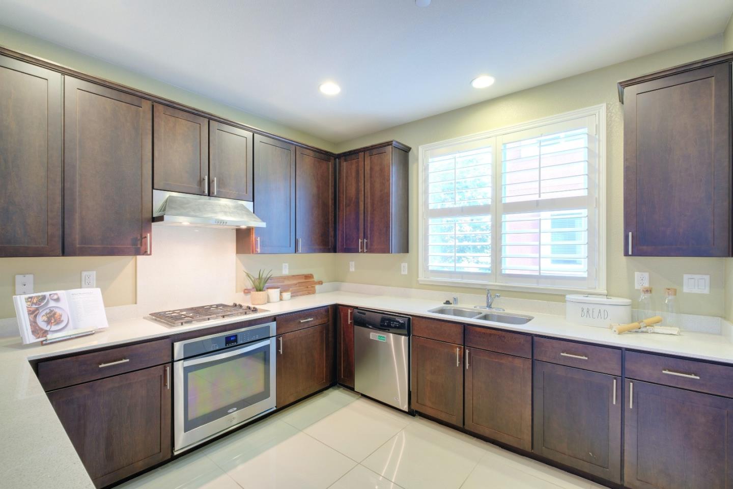 1059 Eagle Way San Jose, CA 95131 - Photo 13 of 56 a kitchen with stainless steel appliances granite countertop wooden cabinets sink and window