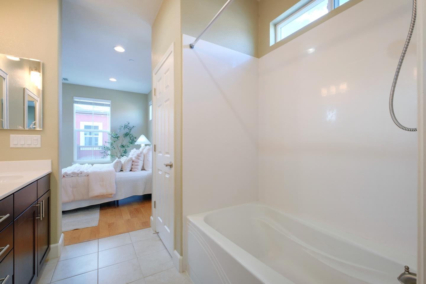 1059 Eagle Way San Jose, CA 95131 - Photo 24 of 56 a bathroom with a tub a sink and a mirror