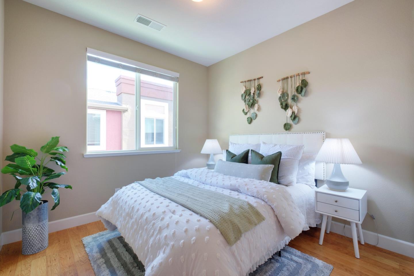 1059 Eagle Way San Jose, CA 95131 - Photo 31 of 56 a bedroom with bed and a potted plant