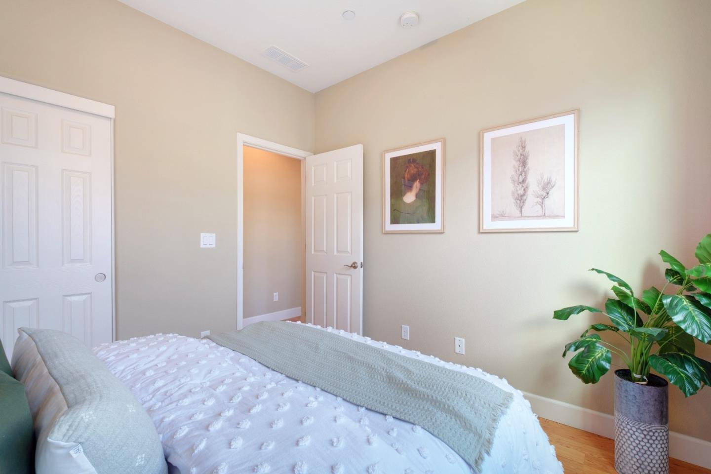 1059 Eagle Way San Jose, CA 95131 - Photo 33 of 56 a bedroom with a bed and a potted plant