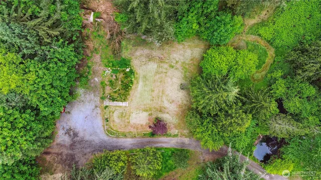 an aerial view of a house with a yard