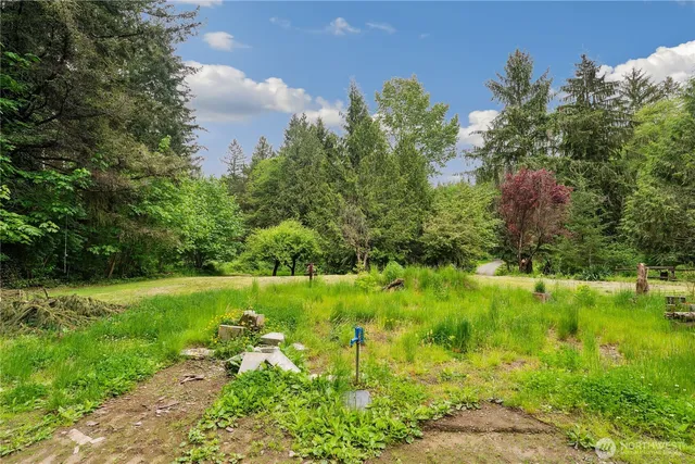 a backyard of a house with a yard and outdoor seating