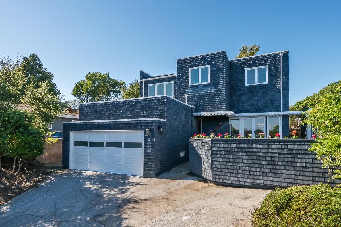a front view of a house with plants
