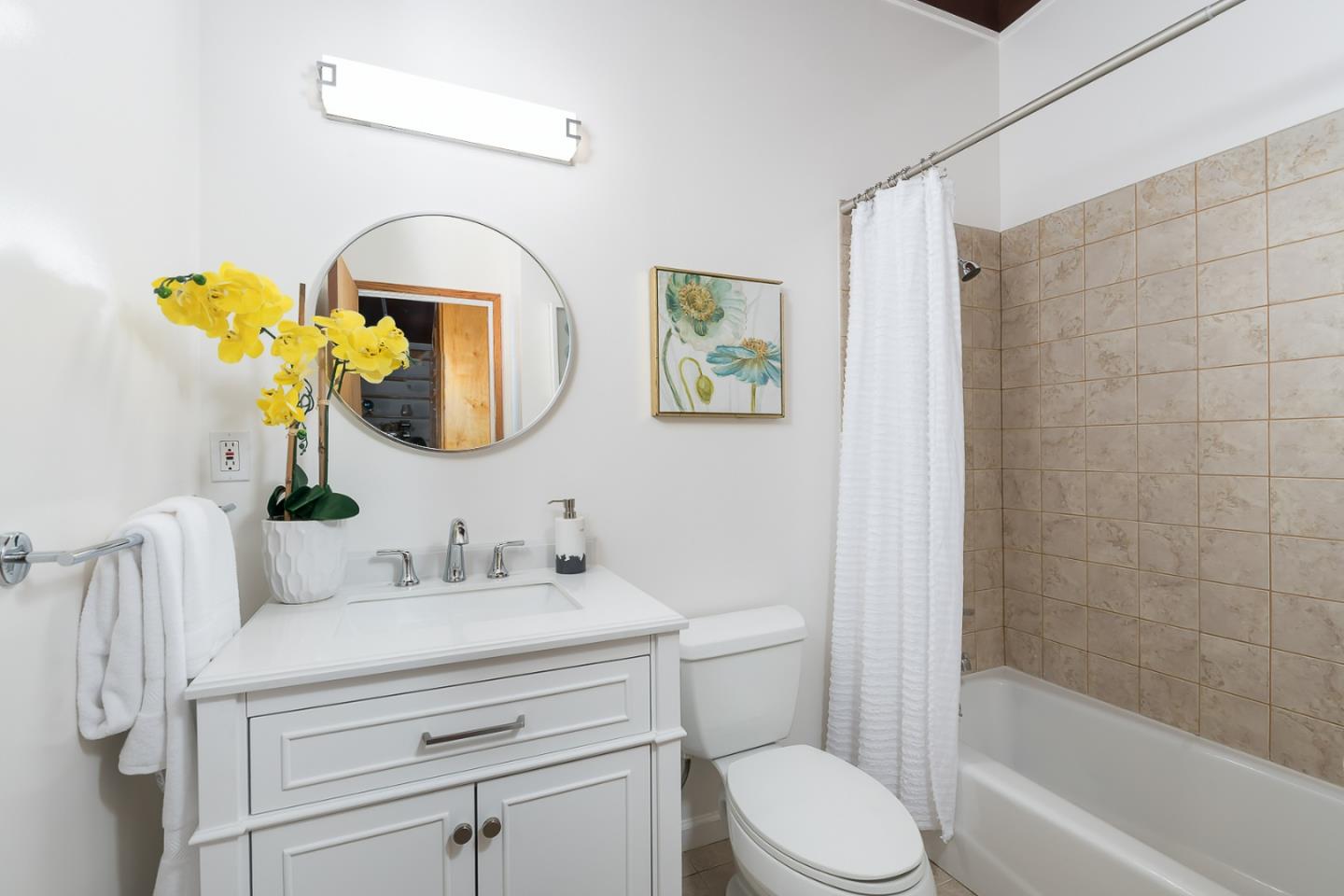 3217 Upper Lock Avenue Belmont, CA 94002 - Photo 12 of 59 a bathroom with a toilet sink and mirror
