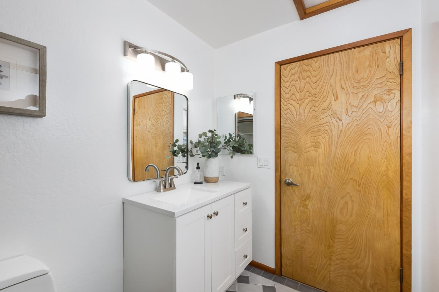 3217 Upper Lock Avenue Belmont, CA 94002 - Photo 27 of 59 a bathroom with a sink and a mirror