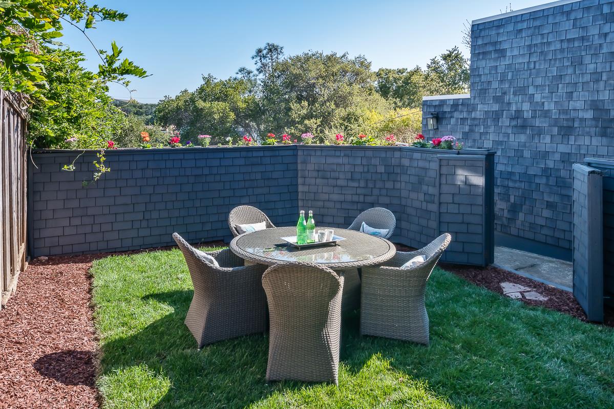 3217 Upper Lock Avenue Belmont, CA 94002 - Photo 31 of 59 a view of a table and chairs in back yard of the house