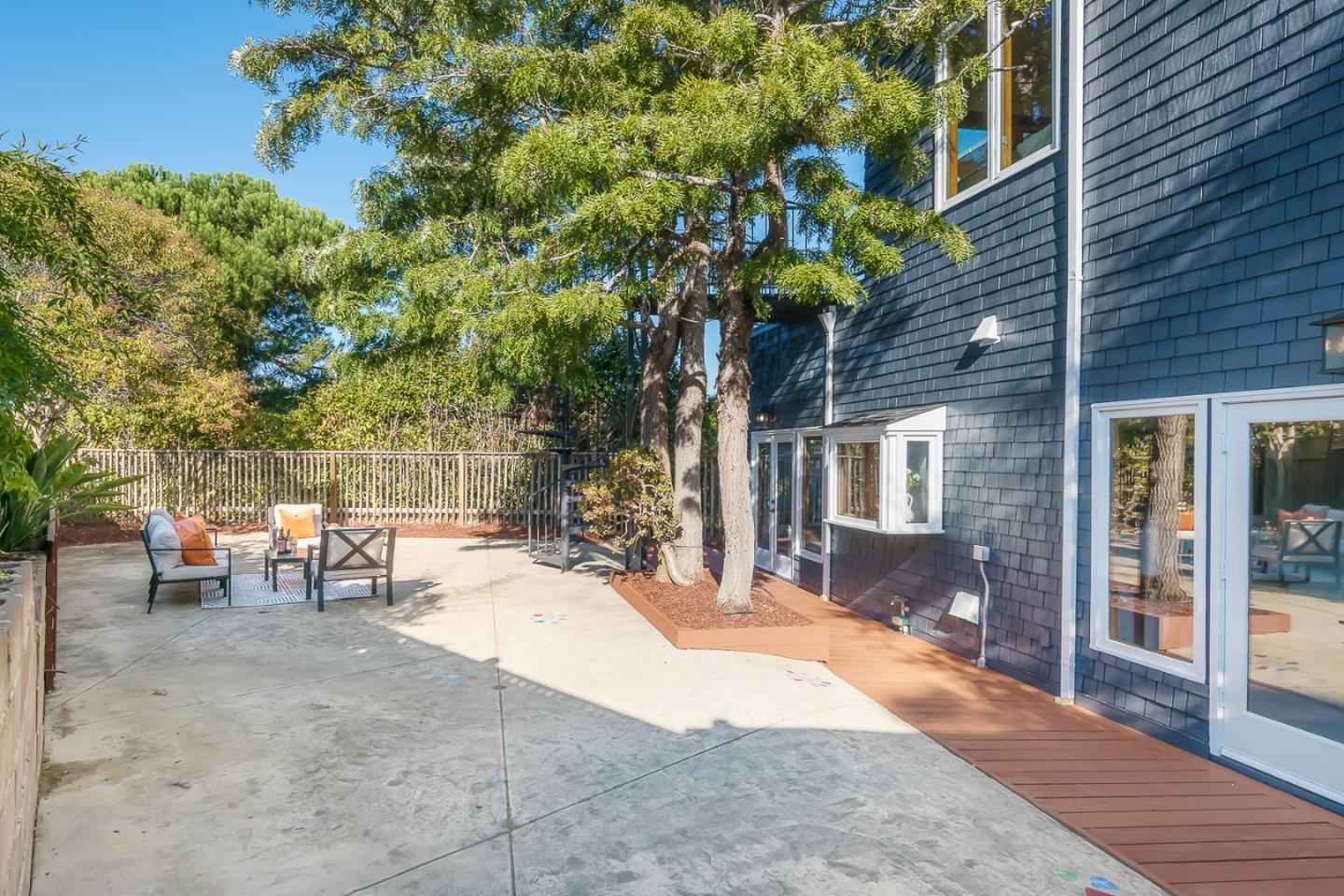 3217 Upper Lock Avenue Belmont, CA 94002 - Photo 35 of 59 a view of a backyard with table and chairs and potted plants