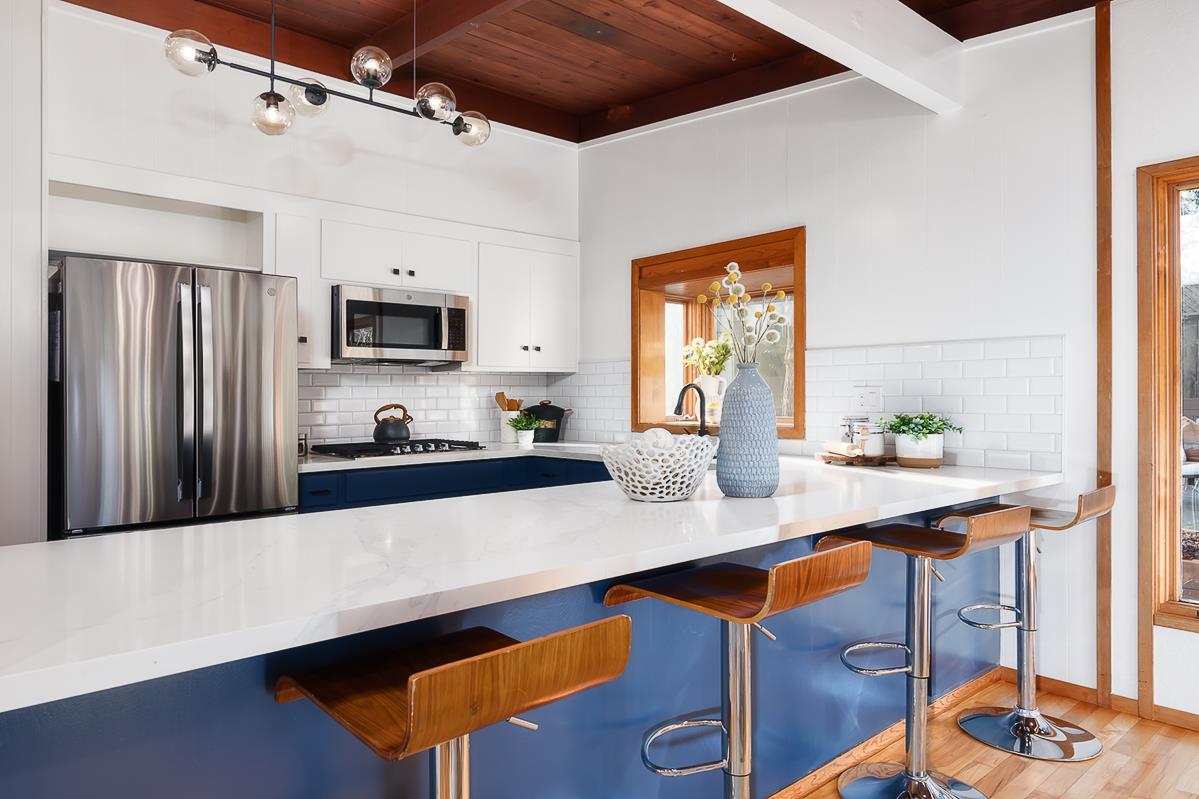 3217 Upper Lock Avenue Belmont, CA 94002 - Photo 6 of 59 a kitchen with stainless steel appliances a sink a stove a refrigerator cabinets and a dining table