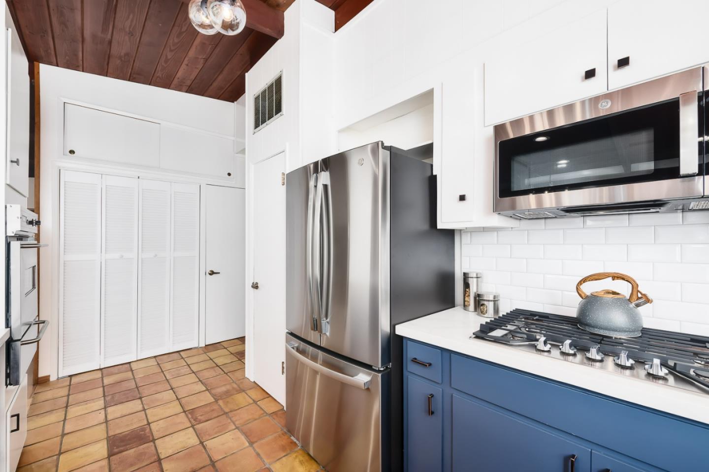 3217 Upper Lock Avenue Belmont, CA 94002 - Photo 9 of 59 a kitchen with stainless steel appliances a refrigerator stove and microwave