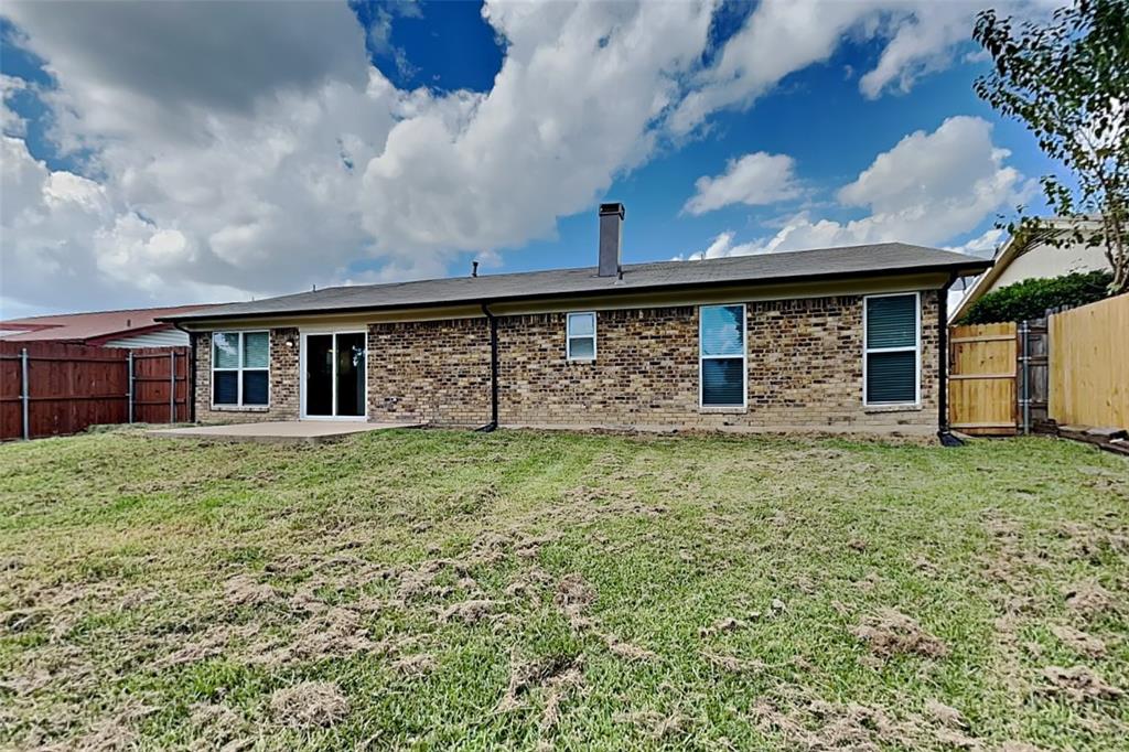 6432 Ridglea Drive Watauga, TX 76148 - Photo 17 of 18 Rear view of house featuring brick siding, a fenced backyard, a patio, and a chimney