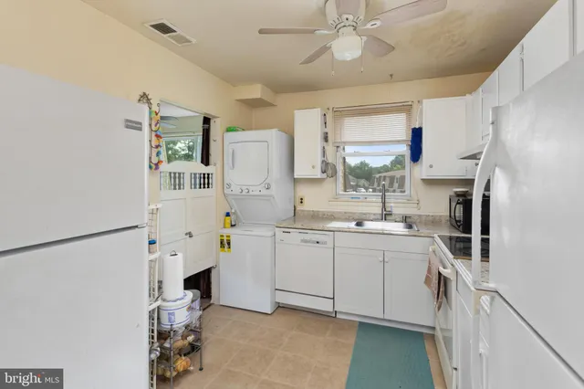 a kitchen with stainless steel appliances a refrigerator sink and cabinets
