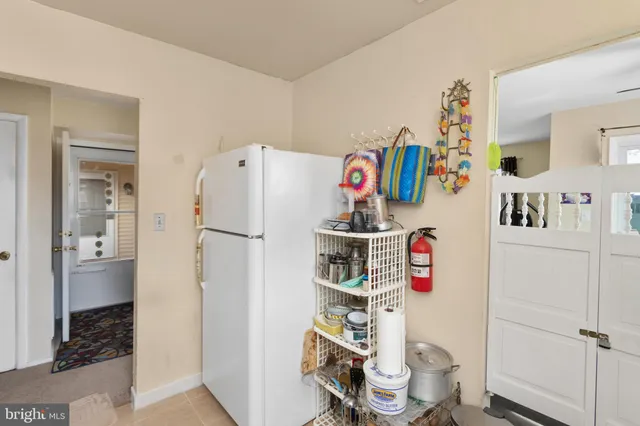 a kitchen with appliances a refrigerator and cabinets