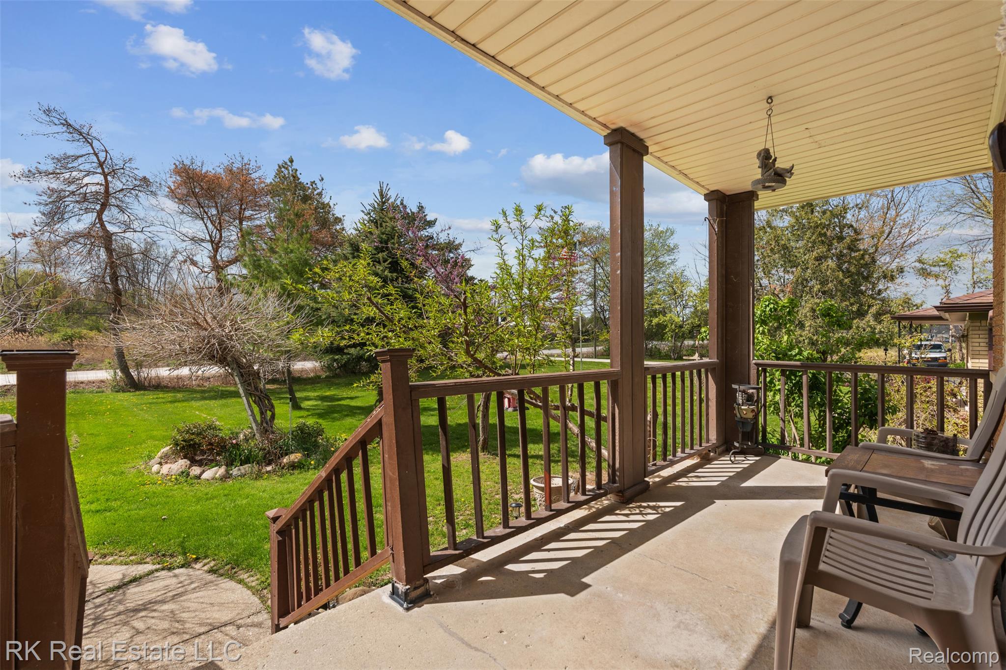 Covered porch featuring a yard