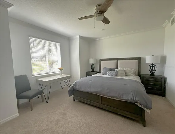 a bedroom with a bed a dresser and a flat screen tv