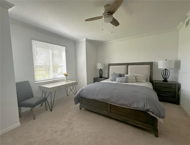 a bedroom with a bed a dresser and a flat screen tv