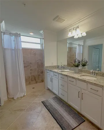 a spacious bathroom with a granite countertop sink a toilet and a mirror