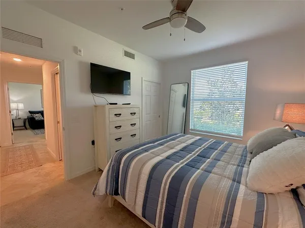 a living room with furniture and floor to ceiling windows