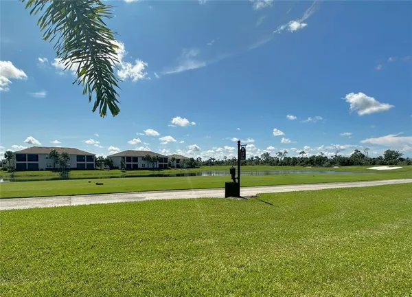 a view of an ocean with a swimming pool and green space