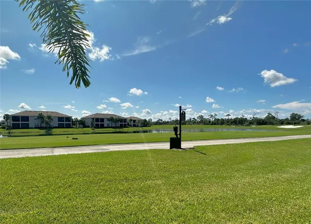a view of an ocean with a swimming pool and green space