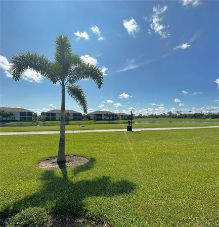 a front view of a house with garden and trees