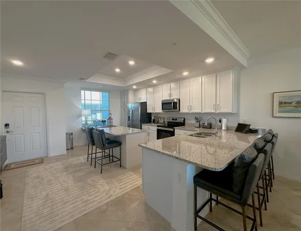 a dining room with furniture a chandelier and wooden floor