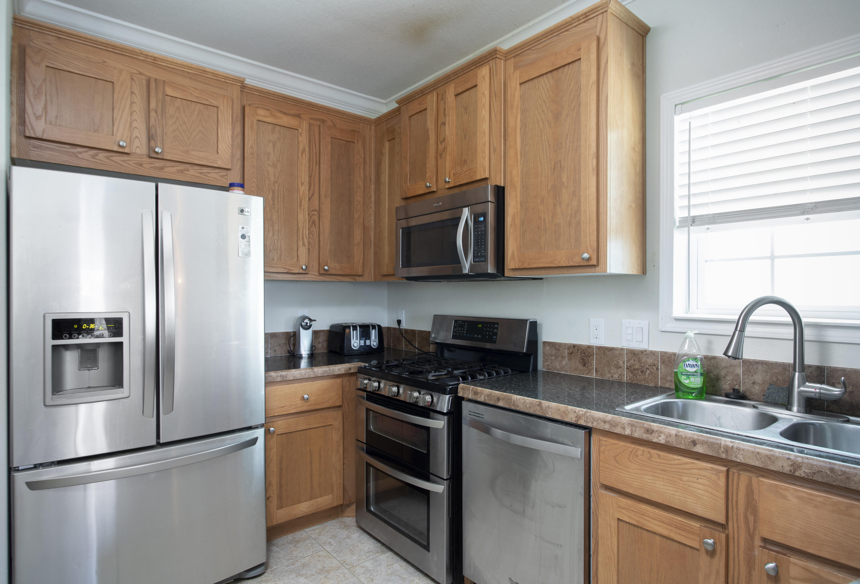 59 Palm Drive Key West, FL 33040 - Photo 6 of 14 a kitchen with stainless steel appliances granite countertop a refrigerator sink and stove