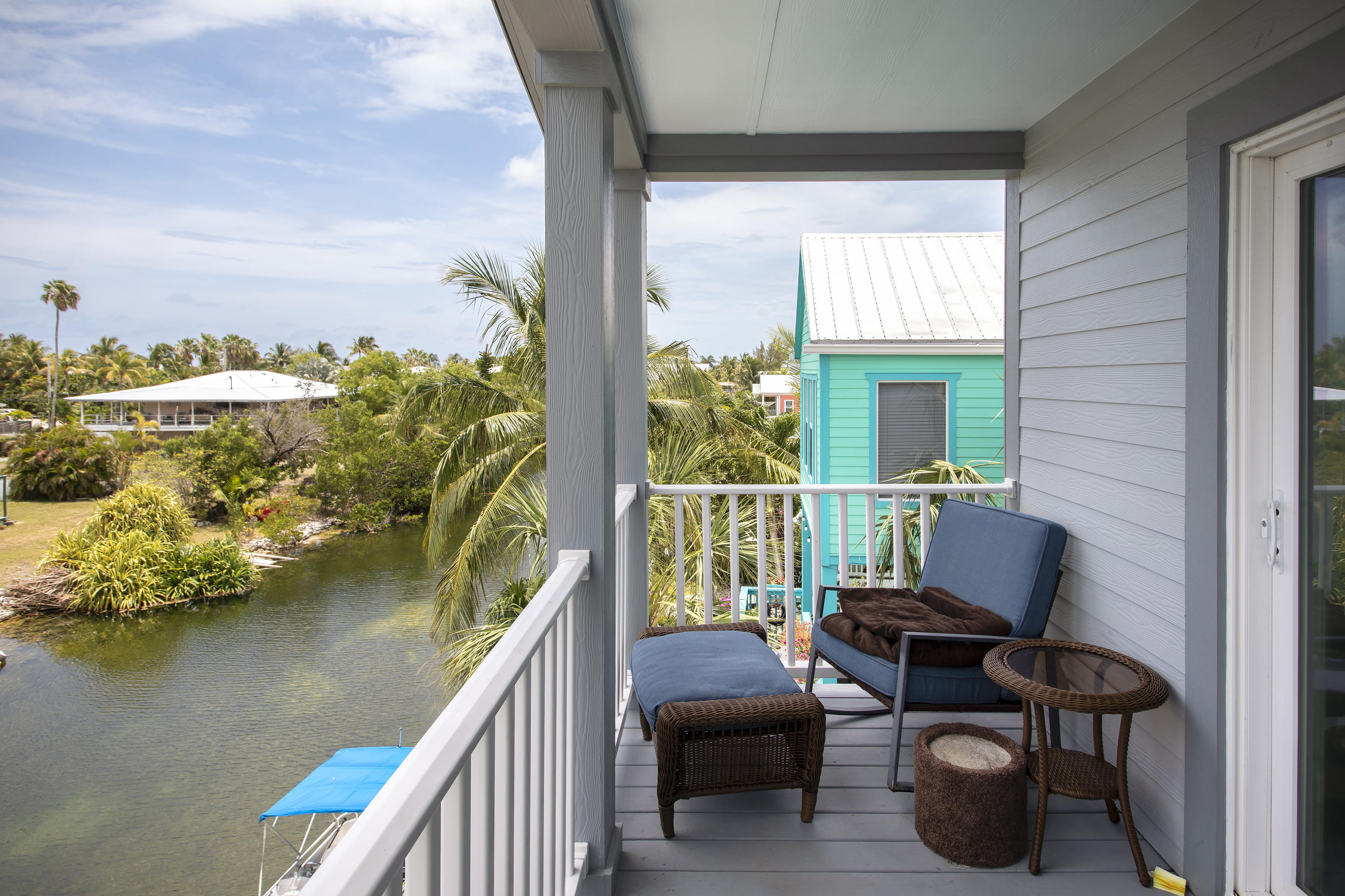 59 Palm Drive Key West, FL 33040 - Photo 10 of 14 a balcony with wooden floor table and chairs