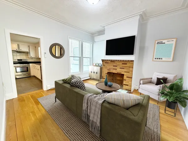a living room with furniture a flat screen tv and a fireplace