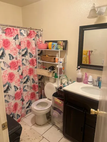 a bathroom with a sink toilet and mirror