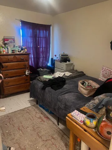 a bedroom with bed and a window