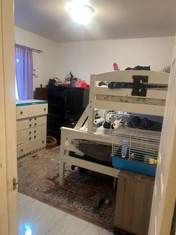 a room with a stove and a refrigerator