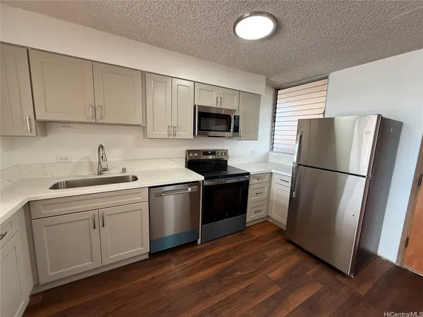 a kitchen with a refrigerator stove and sink