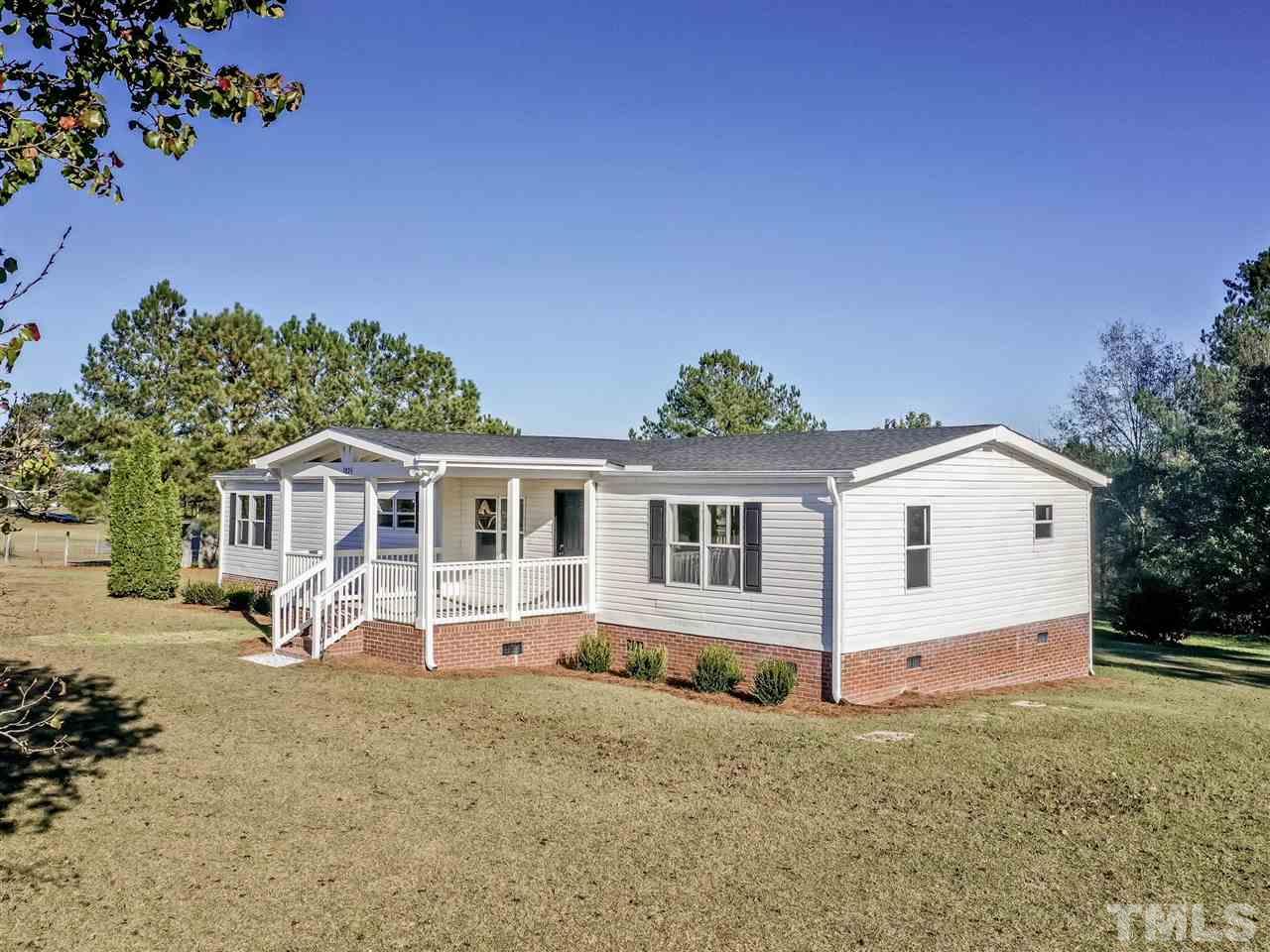 1825 Wire Road Bunnlevel, NC 28323 - Photo 2 of 30 Enjoy quiet country living in your amazing ranch home updated with all the necessities and then some! Brand new rocking chair front porch for those beautiful quiet Bunnlevel days and starry nights.
