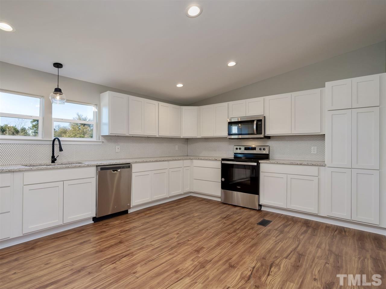 1825 Wire Road Bunnlevel, NC 28323 - Photo 10 of 30 Brand new custom cabinets with new stainless appliances, new backsplash, custom lighting, and granite countertops is the perfect place to gather with the family!