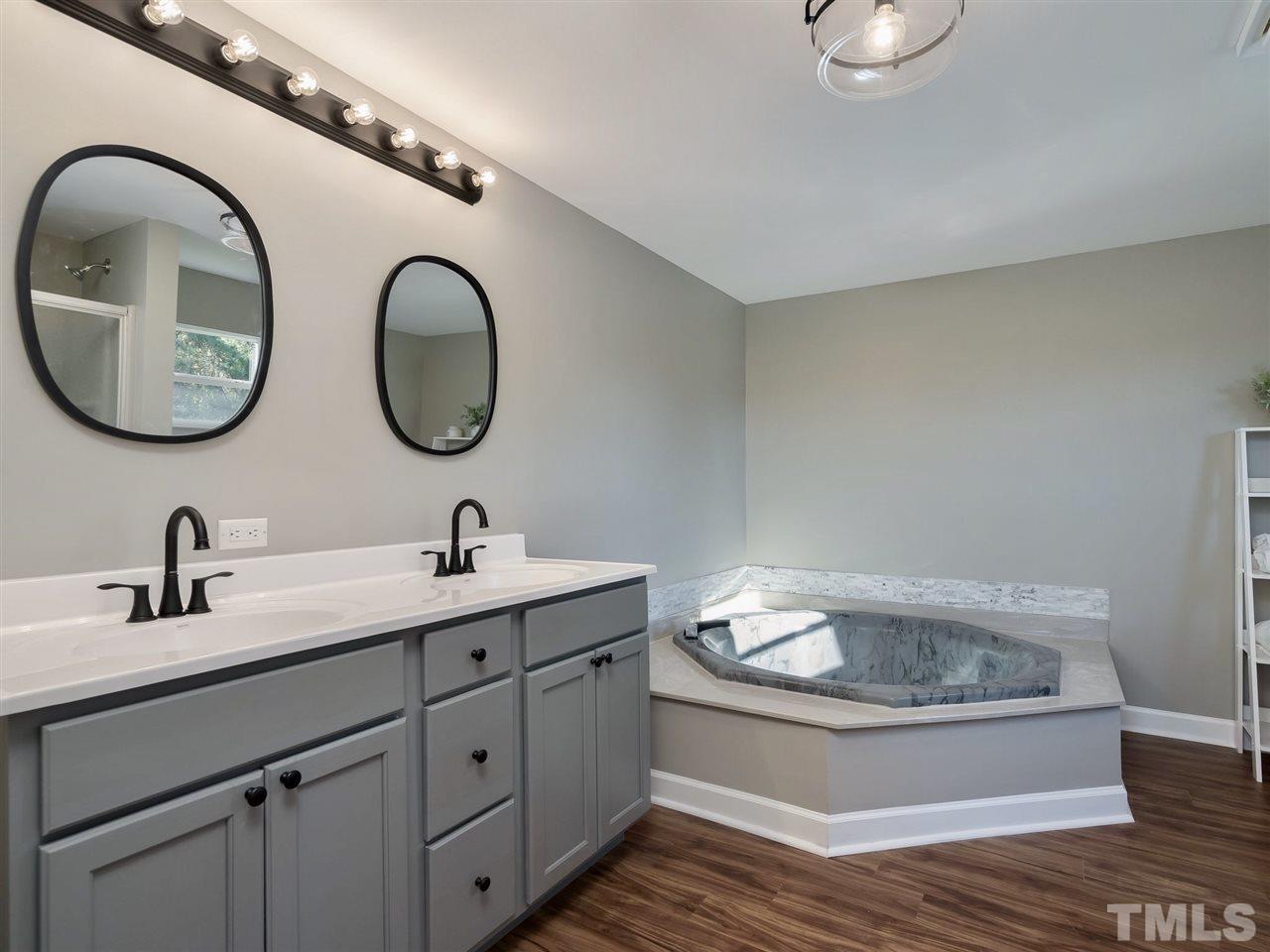 1825 Wire Road Bunnlevel, NC 28323 - Photo 14 of 30 Lose yourself in the master bath/spa with double vanity, separate shower, and garden tub with marble backsplash.